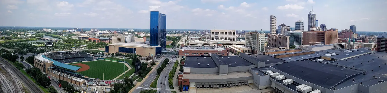 Wide daytime panorama of the downtown Indianapolis, Indiana skyline with the high-rise skyline, Victory Field, and the Indiana Convention Center