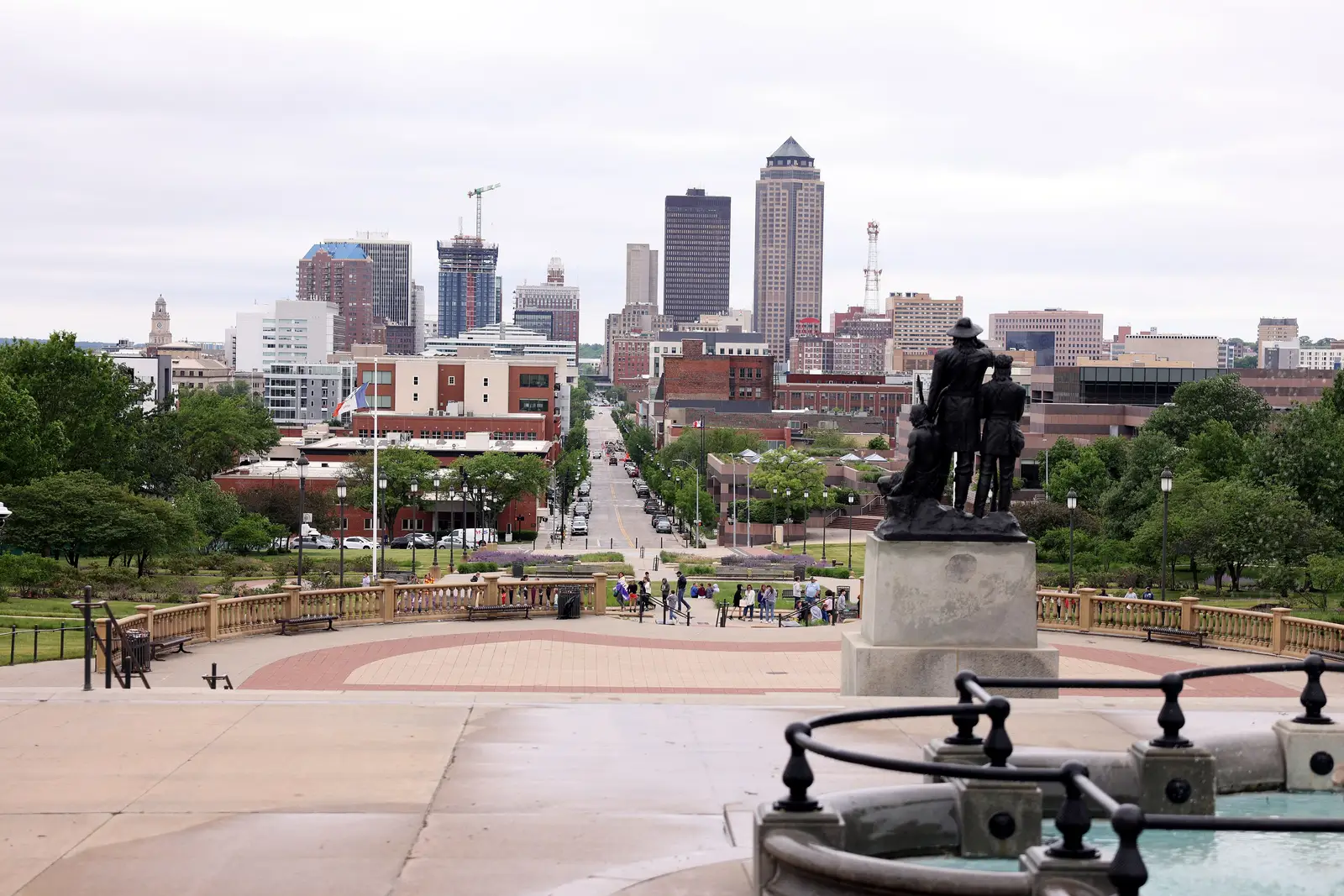 Downtown Des Moines, Iowa skyline viewed from the Iowa State Capitol on a bright morning, showing the city's cluster of modern high-rise buildings