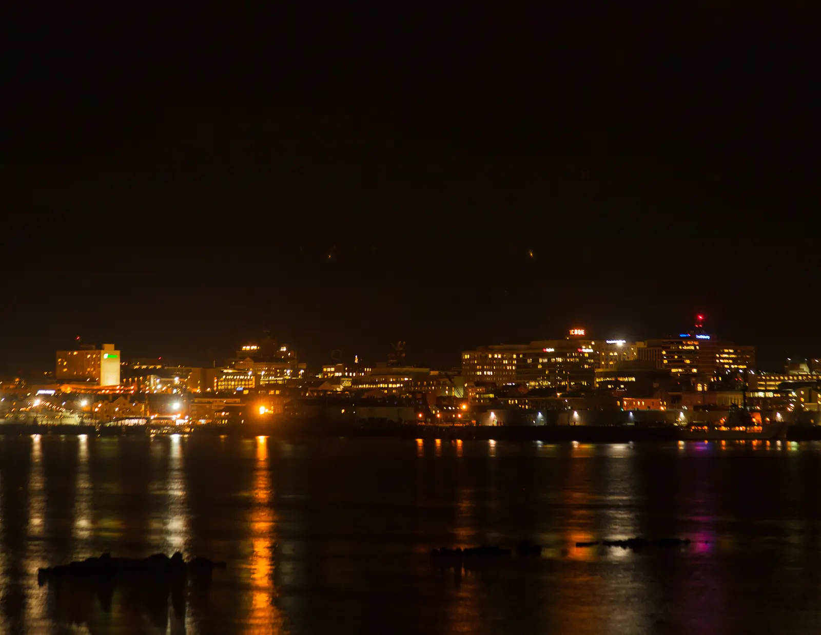 The Portland, Maine skyline viewed across the harbor from South Portland, with the city's waterfront buildings and boats on the water, Maine