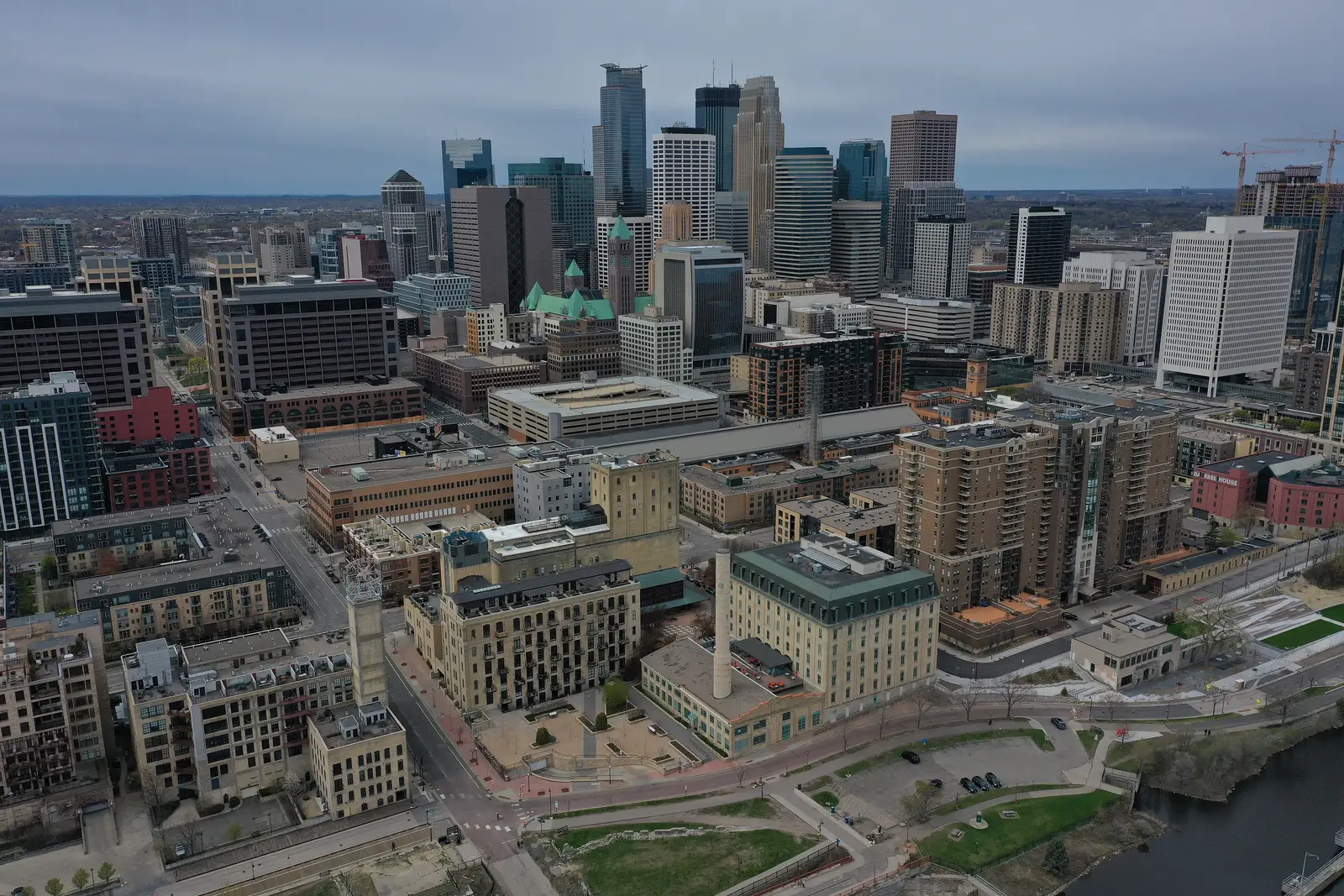 Aerial view of the downtown Minneapolis, Minnesota skyline rising above the Mississippi River and Saint Anthony Falls on a clear day