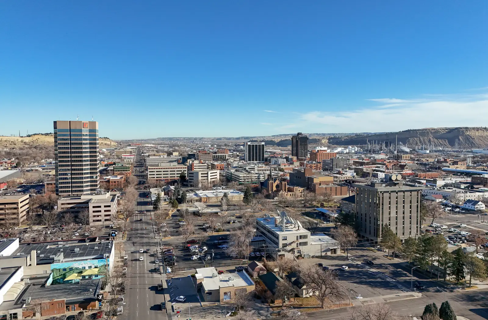 Aerial view of the Billings, Montana skyline with downtown buildings and surrounding landscape under clear daylight, Montana