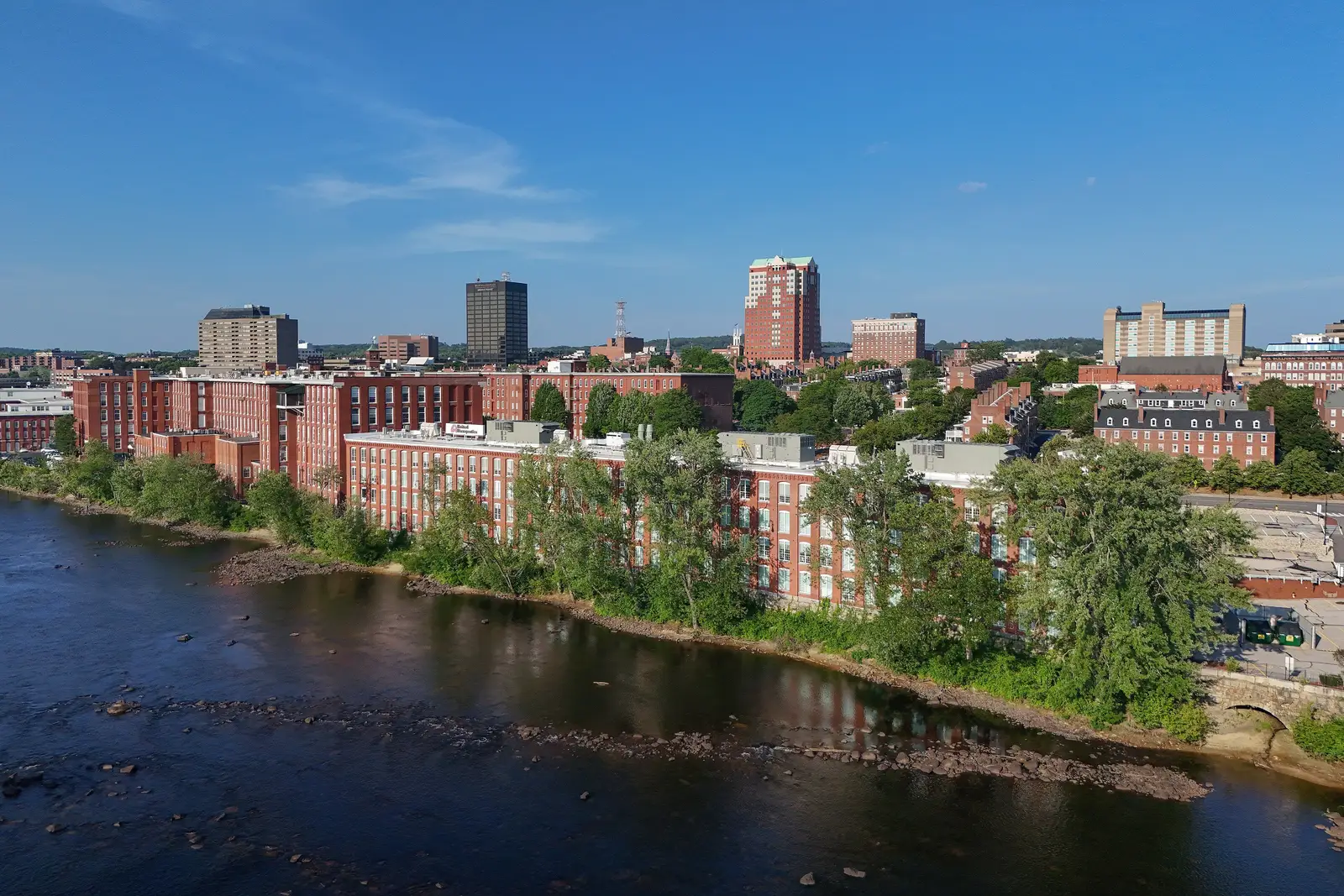 Aerial drone view of the downtown Manchester, New Hampshire skyline on a clear day