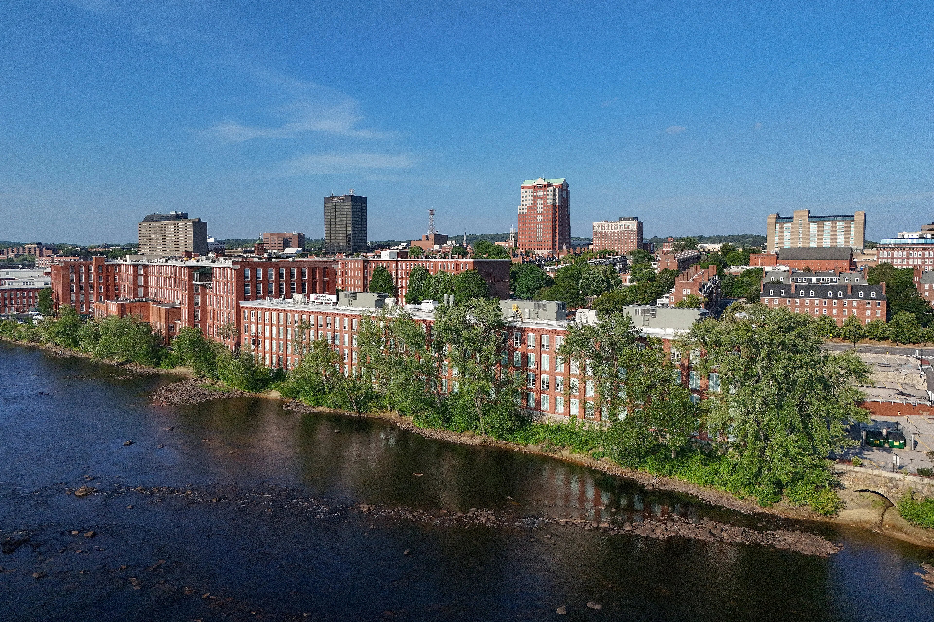 Aerial drone view of the downtown Manchester, New Hampshire skyline on a clear day
