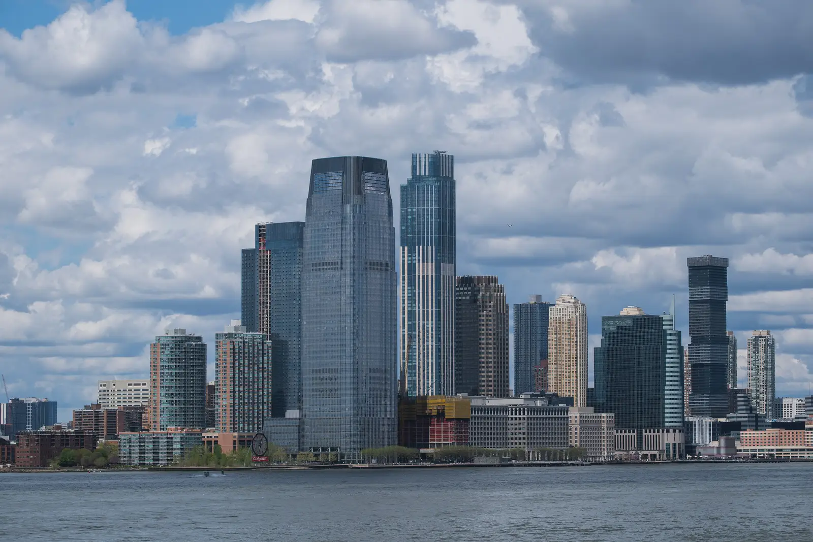 Jersey City skyline viewed across the Hudson waterfront, featuring the Goldman Sachs Tower and the iconic Colgate Clock landmark, New Jersey