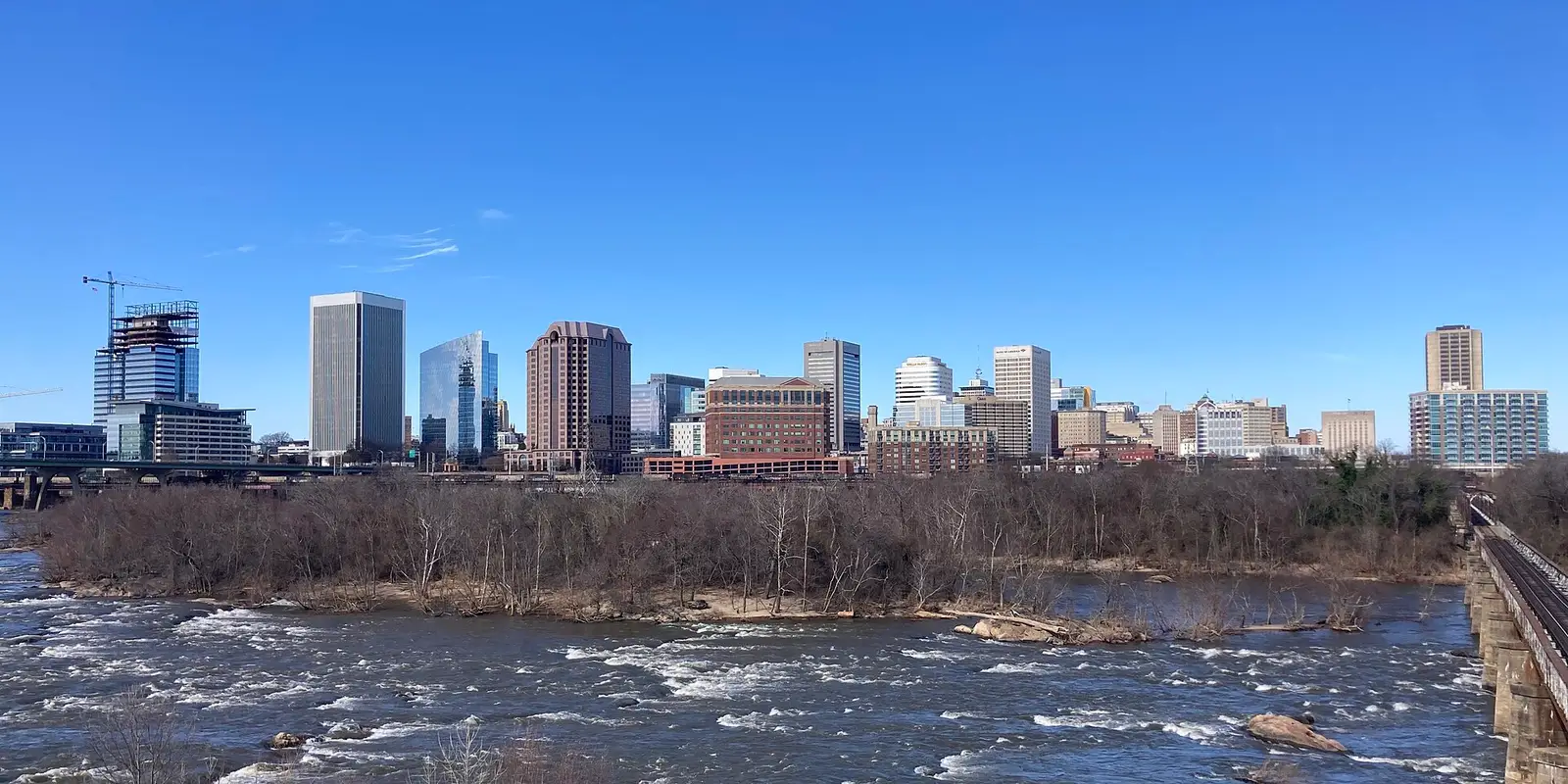 The downtown Richmond skyline viewed across the James River rapids, Virginia