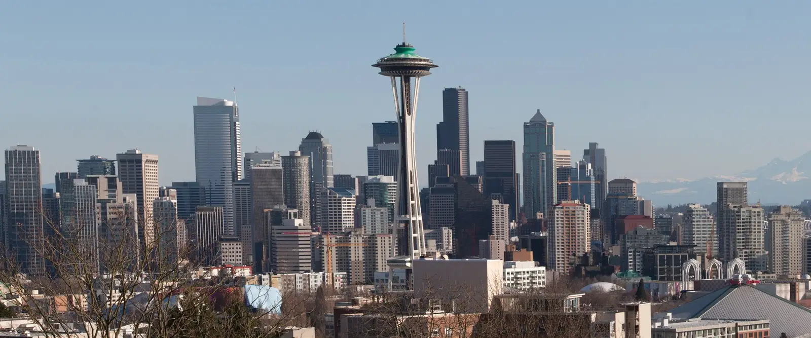 The Seattle skyline with the Space Needle and snow-capped Mount Rainier under a clear sky, Washington