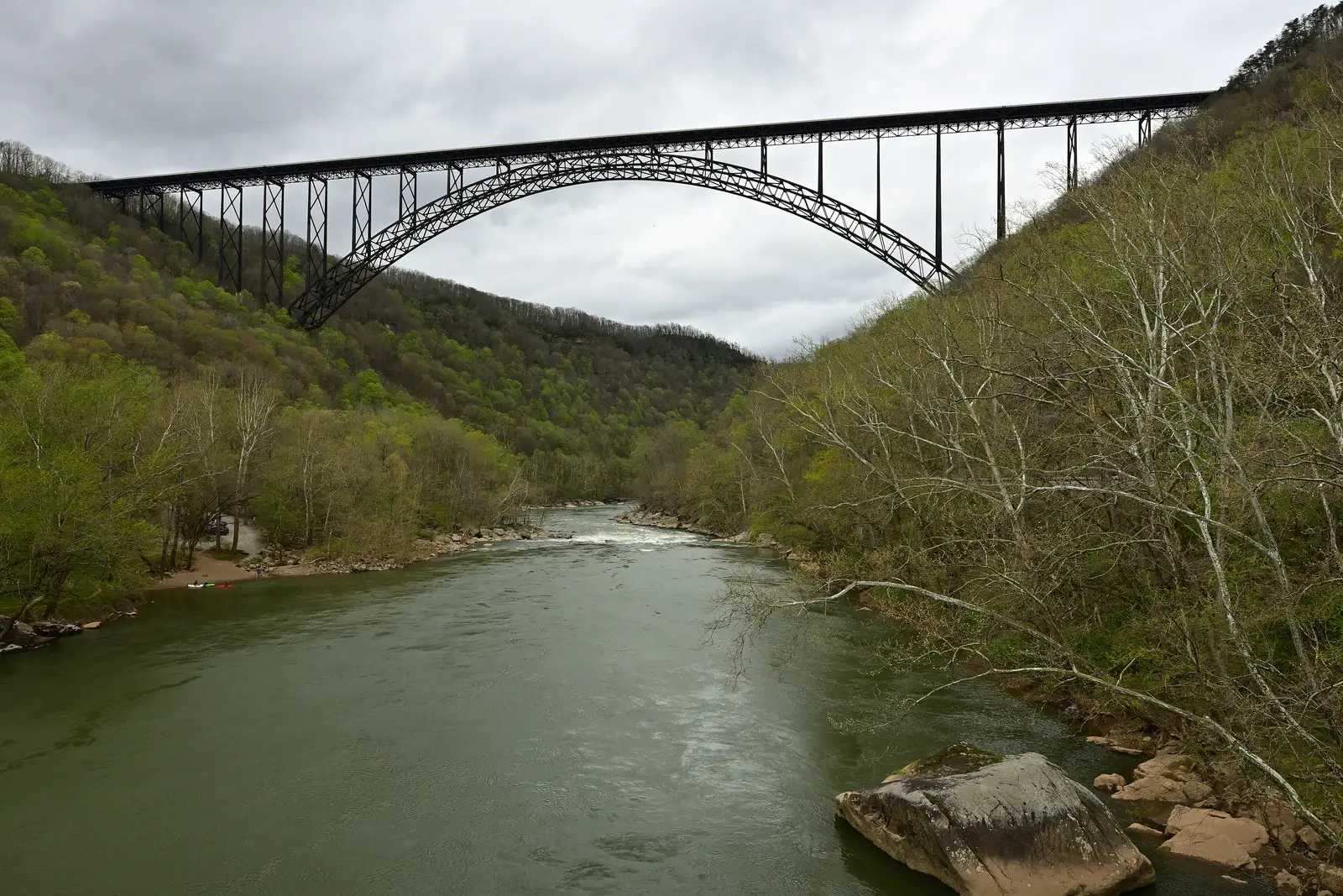 The New River Gorge Bridge, a steel arch bridge spanning the New River Gorge in West Virginia, viewed on a cloudy spring day