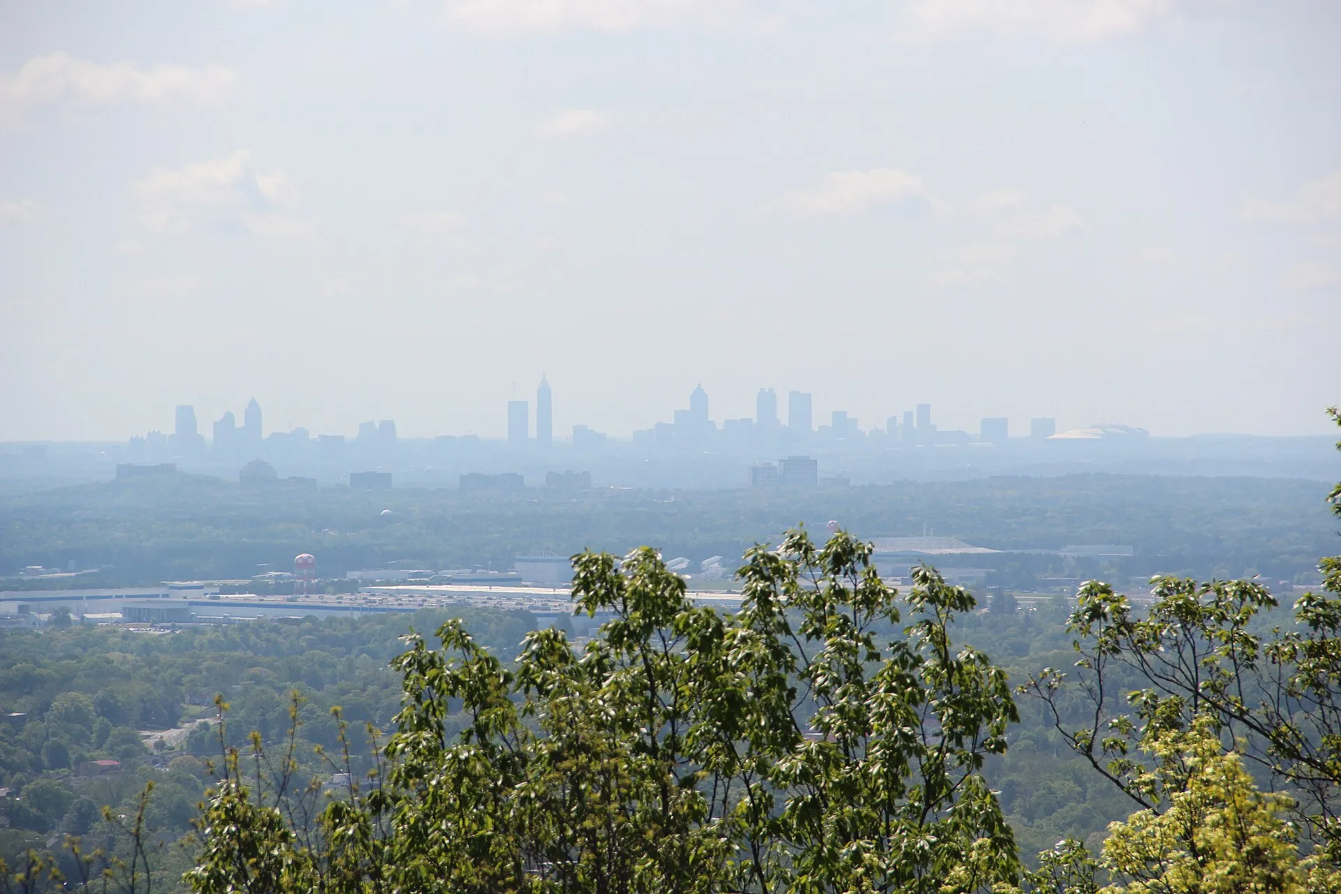 View over the tree-covered suburbs of Cobb County, Georgia from Kennesaw Mountain, with the Atlanta skyline on the horizon