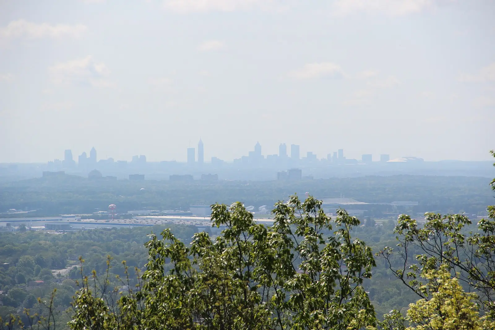 View over the tree-covered suburbs of Cobb County, Georgia from Kennesaw Mountain, with the Atlanta skyline on the horizon