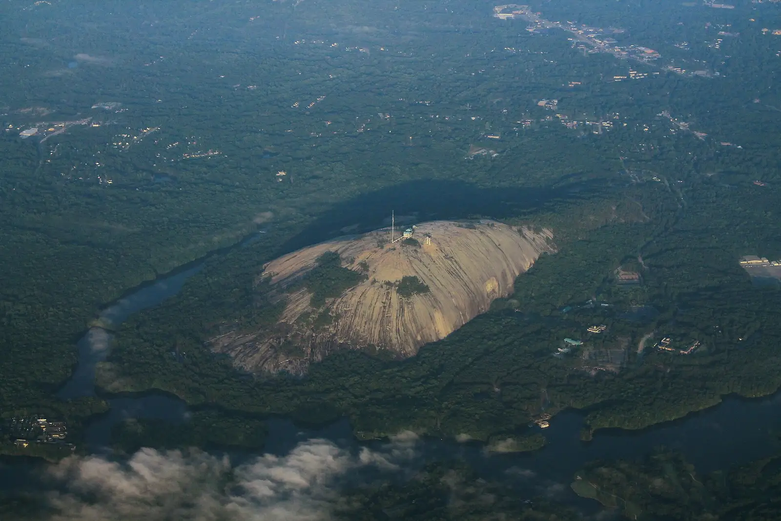 Aerial view of Stone Mountain surrounded by the forests and suburbs of DeKalb County, Georgia