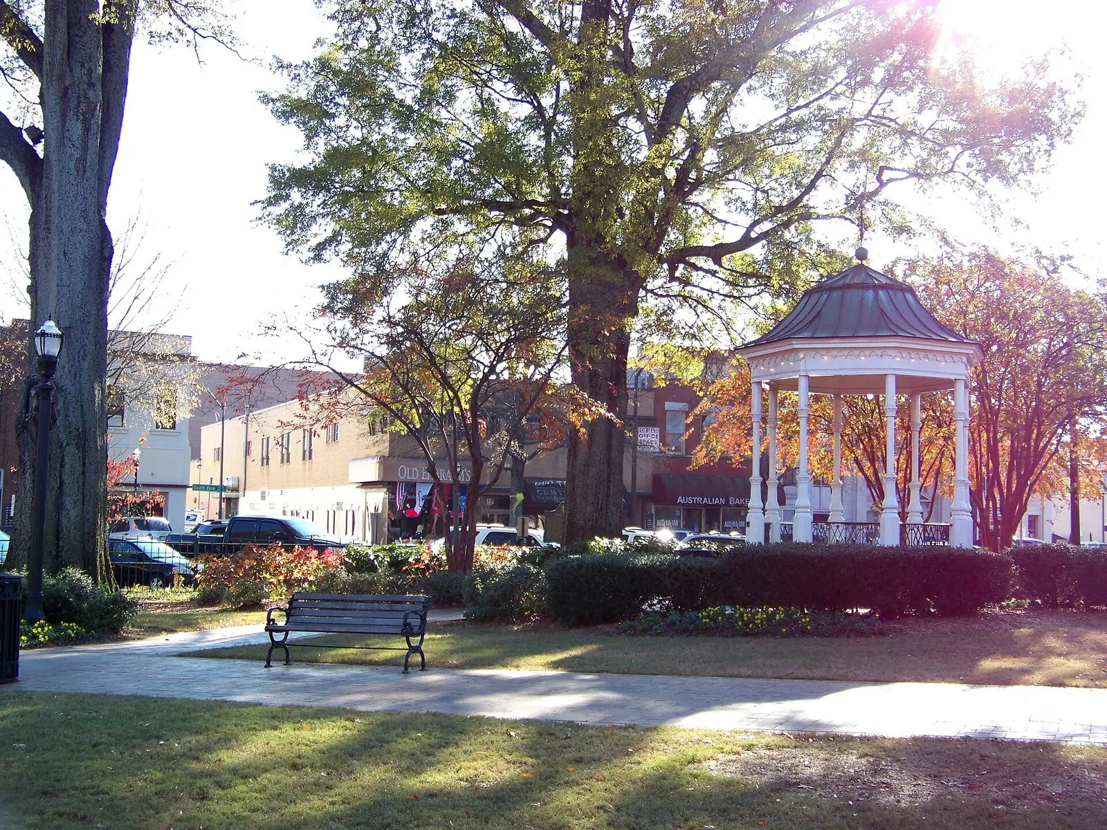 The Victorian bandstand in Glover Park on Marietta Square, framed by shade trees and historic storefronts, in Marietta, Georgia