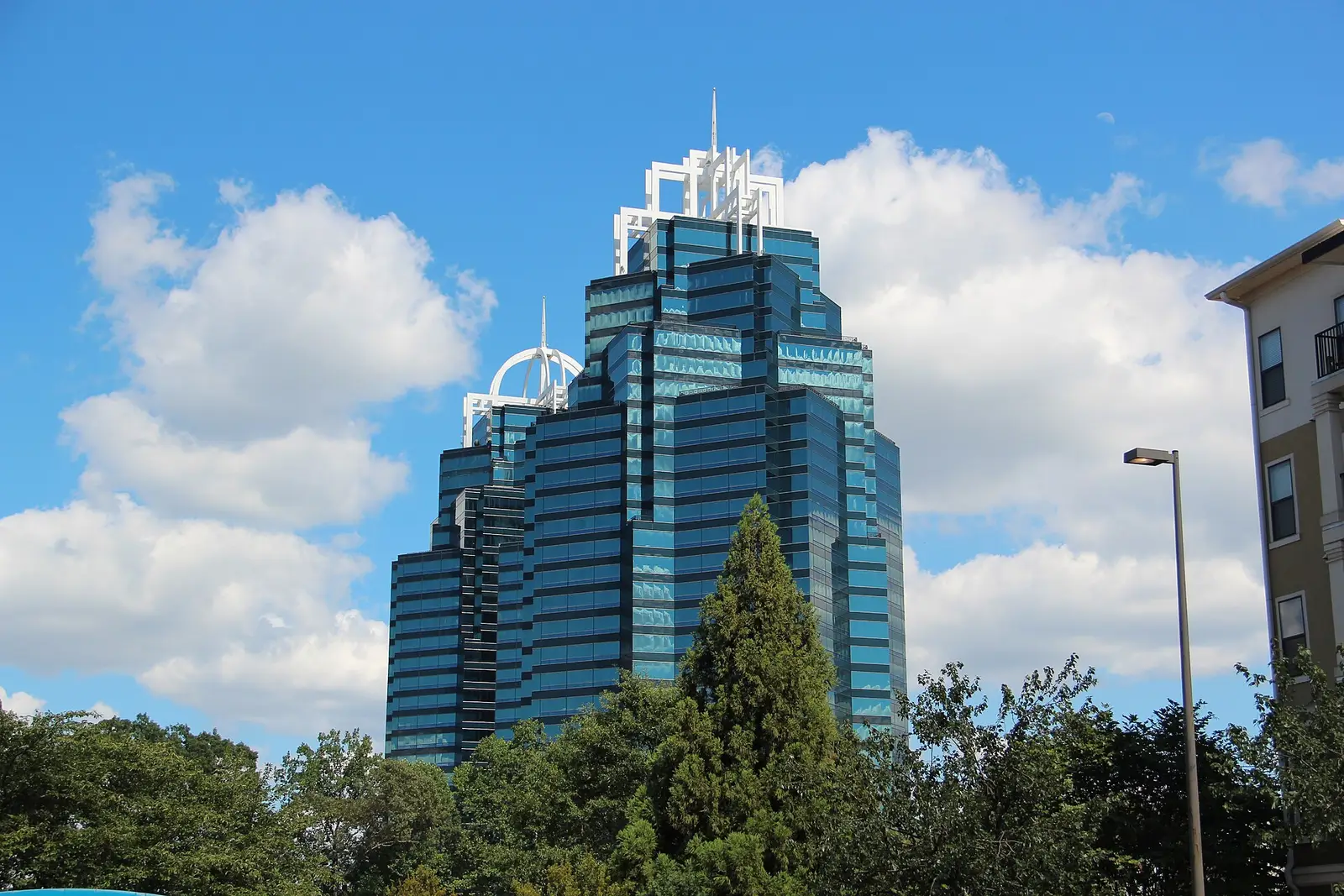 The King and Queen towers of Concourse Corporate Center rising above green treetops in Sandy Springs, Georgia