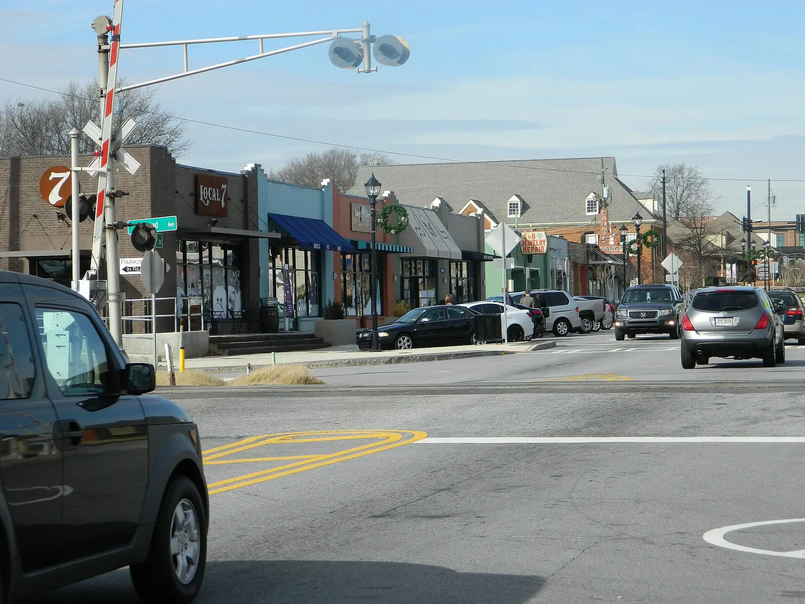 Storefronts along Main Street in downtown Tucker, Georgia, with a railroad crossing signal