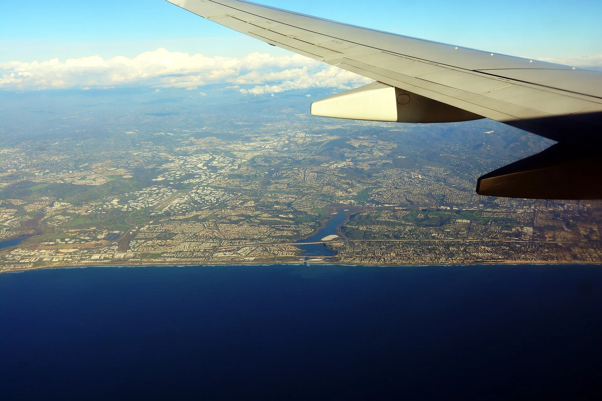Aerial view of the Carlsbad, California coastline, showing beaches, Batiquitos Lagoon, and coastal North County neighborhoods