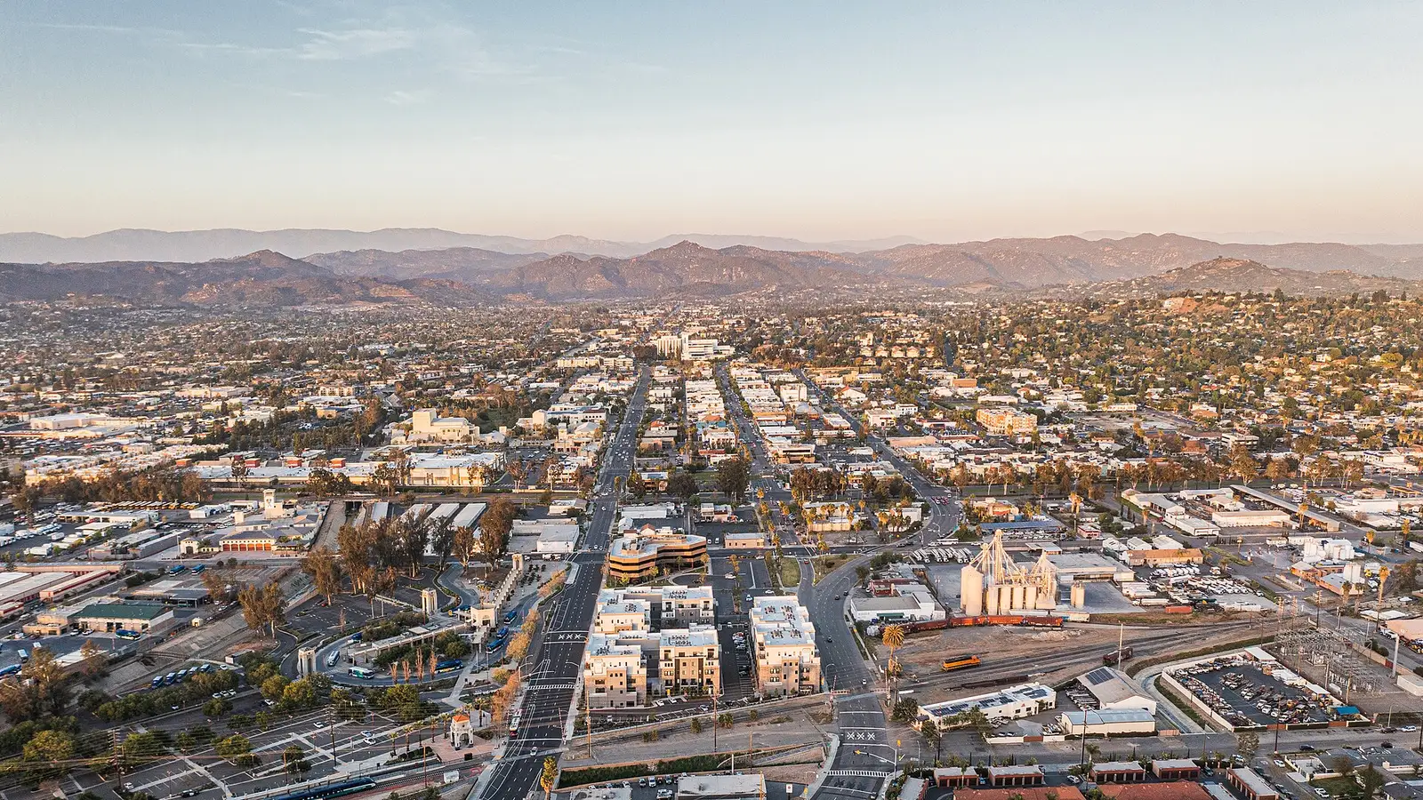 Aerial view of downtown Escondido, California at sunset, with the surrounding inland hills beyond